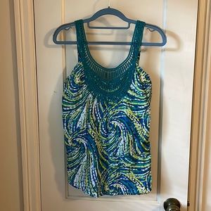 Lovely light summery tank with a fun print and lace detail!